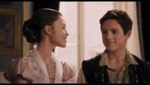 a boy and a girl are looking into each other 's eyes