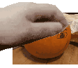 a person is cutting a pumpkin with a knife