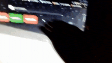 a person 's hand is pressing a button on a computer monitor
