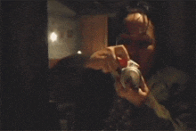 a person is taking a picture with a camera in a dark room