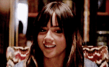 a close up of a woman 's face smiling