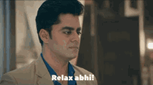 a man in a suit says relax abhi on the screen