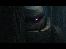 a giant rock monster with purple eyes is standing next to a tree .