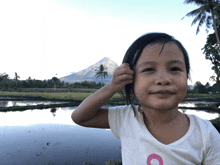 a little girl in a white shirt with the letter o on it