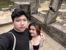 a man and a woman are posing for a picture with the letters sd on the bottom right corner