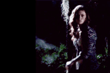 a man in a dark forest with a sword