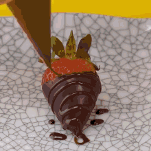 a strawberry covered in chocolate is on a plate