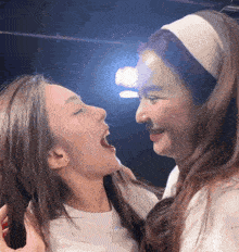 two women are looking at each other with their mouths open