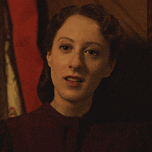 a close up of a woman 's face with her eyes closed in a dark room