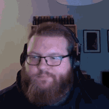 a man with a beard wearing glasses and headphones