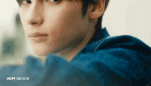 a close up of a person 's face with sbsm written on the bottom right