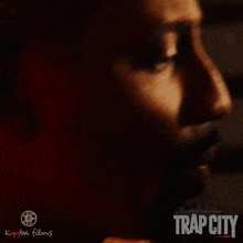 a movie poster for trap city shows a man holding a gun in his mouth