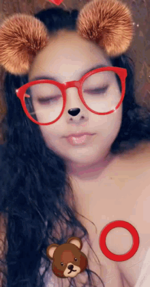 a woman wearing red glasses has a teddy bear icon on her chest