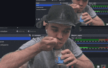 a man in a black hat is eating something from a can
