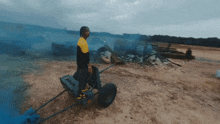 a man in a yellow and black jacket is pushing a cart