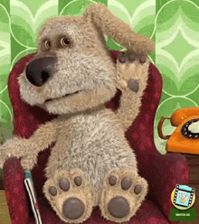 a stuffed dog is sitting in a chair with a cane and waving .