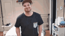 a man wearing a hat and a t-shirt with a pocket that says ' i love you '