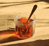 a cup of tea with a spoon in it on a table