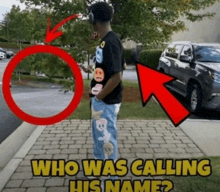 a man wearing headphones is standing on a sidewalk next to a stop sign