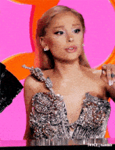 ariana grande is wearing a very revealing dress with a very plunging neckline