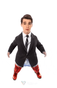 a man in a suit and tie is standing in front of a white background with a v on it