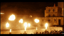 a crowd of people watching a fireworks display with the word cha on the bottom left
