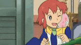 a cartoon girl with red hair is holding a pink fish in her arms