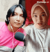 a man and a woman are standing next to each other in front of a microphone with pixverse.ai in the corner