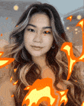 a woman with long hair is surrounded by fire