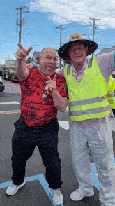 two men are posing for a picture and one of them is wearing a shirt that says " cheesy "
