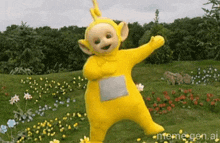 a cartoon character from the teletubbies is dancing in a field of flowers .
