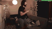 a man with a beard is dancing in front of a couch with a sign that says one way