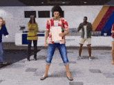 a man in a hawaiian shirt is holding a piece of paper while standing in front of a group of people