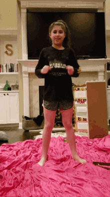 a young girl wearing a black shirt that says " unleashed the force "