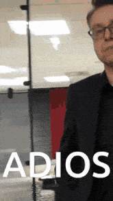 a man in a suit and glasses says adios