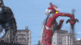 a giant robot is fighting another giant robot in front of a city .