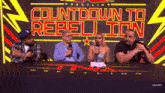 a group of people sitting at a table with the words countdown to rebellion behind them