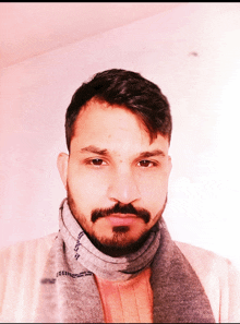 a man with a scarf around his neck has a beard