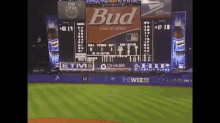 a scoreboard at a baseball game sponsored by bud and etmo