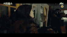 a group of people are fighting in a room with the number 15 on the bottom left
