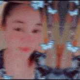 a blurry picture of a woman 's face with a pattern of butterflies behind her .
