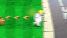 a blurred image of a video game with a few balls on the grass