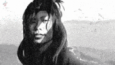 a black and white drawing of a woman with long hair standing in the rain .