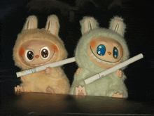 two stuffed animals are holding cigarettes and one has a sticker on it that says ' nicotine ' on it