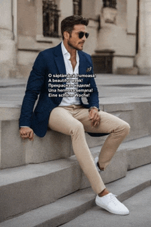a man wearing a blue jacket and khaki pants sits on steps
