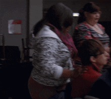 a cheerleader is getting her hair done in front of a crowd