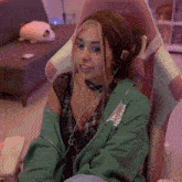 a girl wearing headphones is sitting in a chair that says xg on it