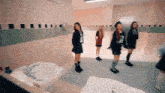 a group of girls standing in a bathroom with a sink
