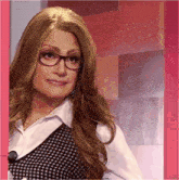 a woman wearing a wig and glasses looks at the camera