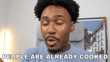 a man with his eyes closed and the words people are already cooked below him